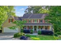 Charming two-story home featuring a welcoming front porch and beautifully landscaped front yard at 210 Malvern Pl, Roswell, GA 30076