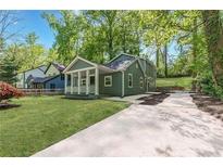 Charming home featuring a well-manicured front yard and a welcoming covered porch at 214 Adeline Nw Ave, Atlanta, GA 30314