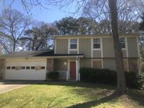 Two story house with a stone facade, lawn, and a two car garage at 432 Rock Meadow Dr, Stone Mountain, GA 30088