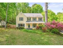 Charming two-story home with green shutters, landscaping, and mature trees at 3627 Pebble Hill Ne Dr, Marietta, GA 30062