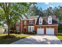 Charming two-story brick home with a well-maintained lawn and attached two-car garage at 3656 Oak Sw Ln, Powder Springs, GA 30127