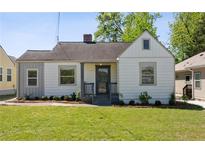 Charming one-story home featuring a well-maintained lawn and a quaint, covered front porch at 1560 Temple Ave, College Park, GA 30337
