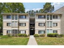 Apartment building exterior featuring traditional architecture, two stories, green lawn and a walkway entrance at 2007 Wingate Way, Atlanta, GA 30350