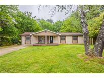 Charming single-story home with a well-manicured lawn and inviting front porch at 110 Valley View Ct, Tyrone, GA 30290