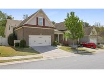Charming two-story brick home with a well-maintained lawn and a two-car garage, located in a desirable neighborhood at 123 Heritage Pointe, Woodstock, GA 30189