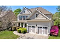 Traditional two-story home featuring a manicured lawn, attached two-car garage, and neutral-colored siding at 2823 Seagrave Way, Marietta, GA 30066