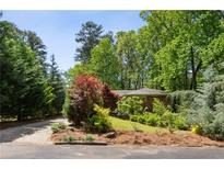Beautiful brick home with mature landscaping and a lush, green yard in a serene setting at 2029 Dover Hill Ne Pl, Atlanta, GA 30345