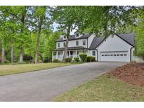 Charming two-story home with a covered porch, attached garage, and beautifully landscaped yard at 191 Gates Mill Dr, Lawrenceville, GA 30045