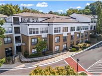 Condominium with three stories, balconies, and professional landscaping and exterior stairwell at 821 Ralph Mcgill Ne Blvd # 2412, Atlanta, GA 30306