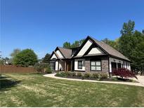 Charming home with manicured lawn, stone accents, and inviting curb appeal at 1076 Pinyan Ln, Canton, GA 30115