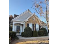 Charming home with stone accents, manicured landscaping, and inviting front porch, offers great curb appeal at 3911 Delfaire Trce, Cumming, GA 30040