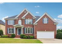 Beautiful two-story brick home with manicured lawn and attached two car garage at 2620 Bent Creek Dr, Cumming, GA 30041