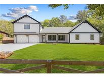 Charming two-story home with black trim, white siding, two-car garage and expansive front lawn at 915 John Ward Rd, Marietta, GA 30064