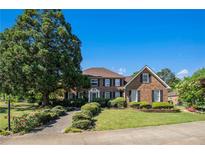 Charming two-story brick home featuring a well-manicured lawn and mature landscaping at 2405 Old Salem Se Rd, Conyers, GA 30013