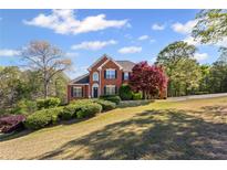 Charming two-story brick home featuring manicured landscaping and a well-maintained lawn in a peaceful setting at 4631 Crooked Creek Ln, Villa Rica, GA 30180