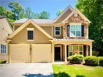 Charming two-story home with a two-car garage and stone facade at 365 Friars Head Dr, Suwanee, GA 30024