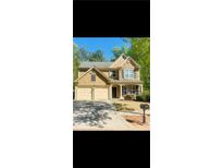 Charming two-story home featuring a two-car garage, stone accents, and well-maintained landscaping at 365 Friars Head Dr, Suwanee, GA 30024