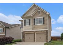 Charming two-story home featuring a two-car garage and neutral siding under a bright blue sky at 4044 Elsdon Dr, Austell, GA 30106