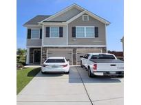 Inviting two-story home featuring a two-car garage and neutral siding at 4044 Elsdon Dr, Austell, GA 30106