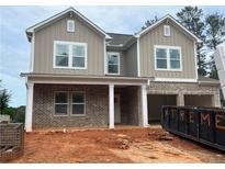 Charming two-story home with brick accents and a covered front porch, awaiting landscaping at 3536 Dogwood Pass, Stonecrest, GA 30038