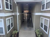 Inviting exterior entrance to condo unit with visible address and stairwell access at 5147 Roswell Rd # 9, Atlanta, GA 30342