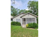 Charming bungalow featuring a quaint screened porch and mature landscaping in a peaceful residential neighborhood at 502 S Evelyn Nw Pl, Atlanta, GA 30318