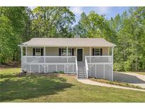 Charming home with a welcoming front porch and well-maintained lawn at 201 Rustin Dr, Dallas, GA 30157