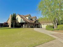 Beautiful two-story home with a well-manicured lawn and three-car garage at 216 Slate Dr, Buford, GA 30518