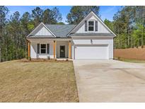 Charming one-story home featuring a two-car garage, a welcoming front porch, and a well-maintained lawn at 1408 Campbell Rd, Covington, GA 30014