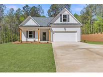 Charming single-story home featuring a welcoming front porch, attached garage, and freshly manicured lawn at 1408 Campbell Rd, Covington, GA 30014