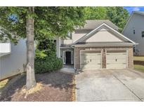 Charming home featuring a two-car garage, beautiful brick accents, and lovely front yard landscaping at 3610 Darcy Ct, Kennesaw, GA 30144