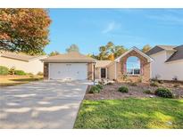 Charming single-story home with a brick facade, attached garage, and a well-manicured lawn at 2416 Centennial Hill Nw Way, Acworth, GA 30102