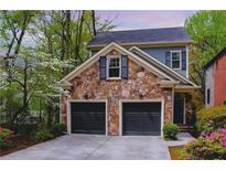 Charming two-story home featuring stone accents, a two-car garage, and professionally landscaped yard at 1048 Standard Ne Dr, Brookhaven, GA 30319