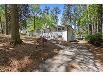 Sprawling single Gathering home with a driveway leading up to a well-maintained front yard at 964 Crane Ne Rd, Atlanta, GA 30324