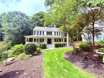 Charming two-story home with a manicured front yard and inviting front porch at 57 Glenn Eagles Way, Hiram, GA 30141