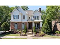 Charming two-story home with brick and stone accents, beautiful landscaping, and a welcoming front porch at 4675 Lakeway Pl, Alpharetta, GA 30005