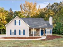 Charming home featuring stone accents, a chimney, and a well-maintained lawn at 124 Williams Blf, Mcdonough, GA 30252