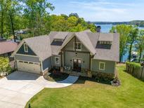 Charming home features a craftsman-style exterior, a spacious garage and a beautifully landscaped lawn at 5635 Cherokee Trce, Cumming, GA 30041