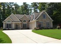Charming single Gathering home with stone accents and a well manicured lawn in a lovely residential neighborhood at 40 Templeton Ln, Villa Rica, GA 30180