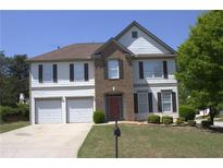 Traditional two-story home with a well-manicured lawn, two-car garage and neutral color palette at 3152 Spruce Way, Atlanta, GA 30349