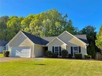 Charming home featuring a manicured lawn, a two-car garage, and a well-maintained landscape at 2536 Caray Ne Ct, Lawrenceville, GA 30043