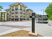 Modern condo building with visible rail trail signage, offering convenient access to nearby amenities and attractions at 5300 Peachtree Rd # 3601, Atlanta, GA 30341