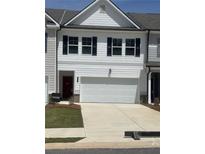 Charming townhome with a two-car garage and a manicured front lawn, creating an inviting curb appeal at 6425 Rosetta Drive, Unit 65, South Fulton, GA 30331