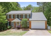Traditional brick home with black shutters, white trim, and a well-manicured lawn at 2794 Kakki Ct, Marietta, GA 30062