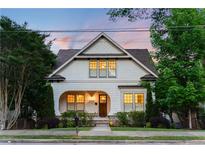 Charming two-story home featuring an arched front porch and beautifully landscaped front yard at 248 Madison Ave, Decatur, GA 30030
