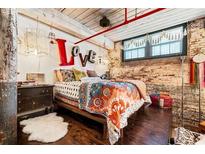 Bright bedroom boasts exposed brick, wood floors and beams, and LOVE decor at 170 Boulevard Se # E003, Atlanta, GA 30312