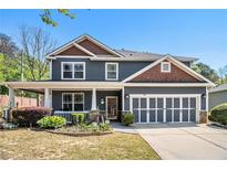 Charming two-story home featuring a welcoming front porch and a well-maintained, landscaped front yard at 1699 Boulder Walk Se Dr, Atlanta, GA 30316