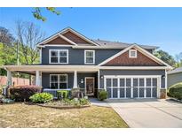 Charming two-story home with a well-manicured lawn, covered porch and attached two car garage at 1699 Boulder Walk Se Dr, Atlanta, GA 30316
