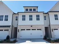 Charming home featuring a wide two-car garage and classic architectural details at 2405 Malster Ln, Lawrenceville, GA 30043