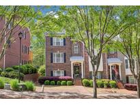 Charming brick townhome with manicured landscaping and inviting front entrance at 1429 Ferocity Ridge Nw Way # 12, Kennesaw, GA 30152